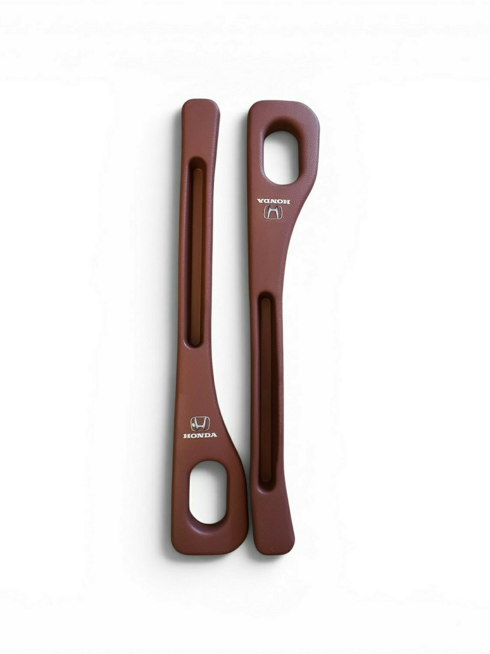 Honda branded in burgundy plastic inserts are designed as car seat gap fillers.